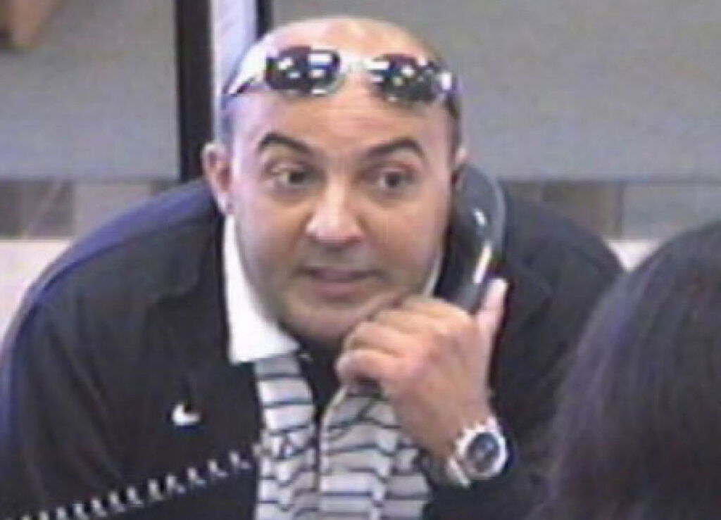 Mugshot of Moundir Kamil, convicted in the surf lot theft ring. Kamil has prior convictions including bank fraud and robberies that earned him the nickname "Give Me More Bandit."