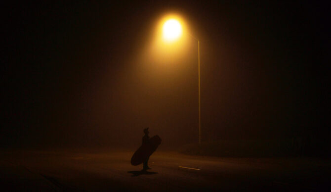 A surfer navigating the challenges of night surfing conditions