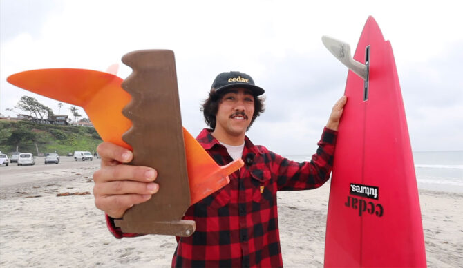 Zack Flores holding three experimental surfboard fins